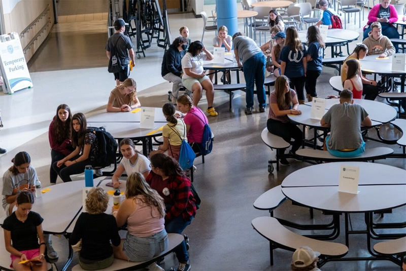 Overzichtsfoto van studenten in een cafetaria.
